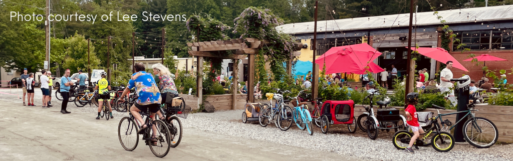 Photo of cyclists gathered on the Ecusta Trail outside of Trailside Brewing in Hendersonville. Photo courtesy of Lee Stevens.